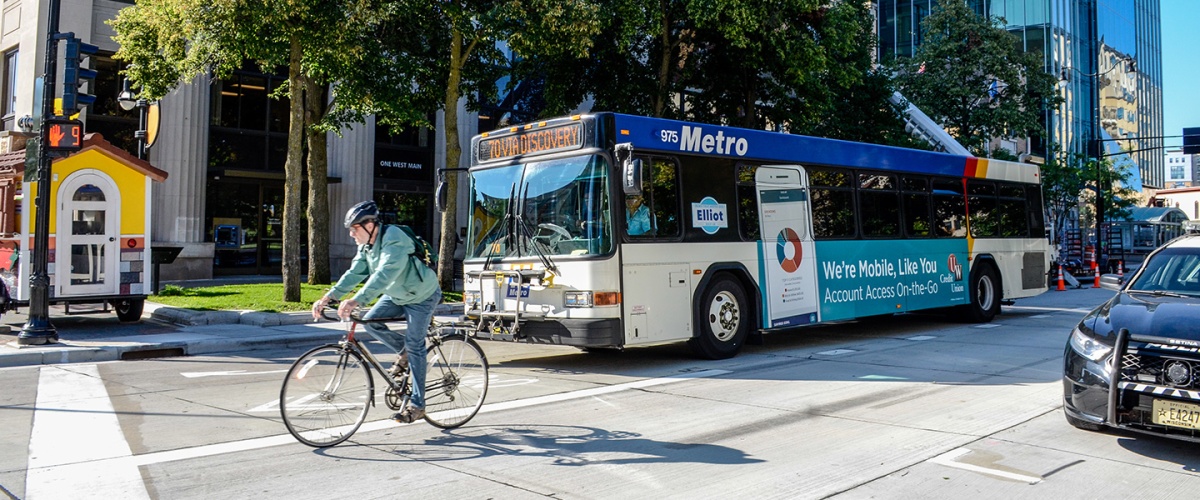 Metro Transit bus on the square, cyclist in the foreground