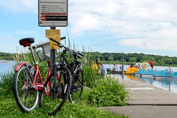 Pier with boats in the water, and bikes parked nearby.